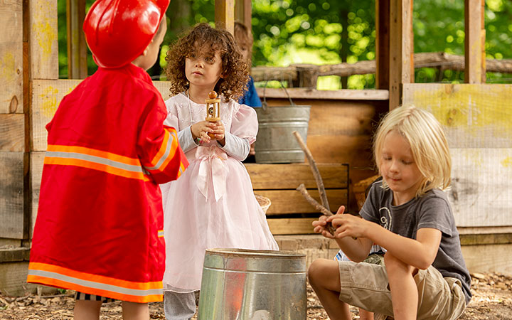 Cooperative or organized supplementary play by three pre-school aged children