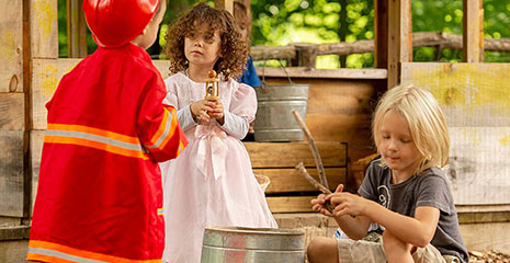 Three children playing, illustrating one of Mildred Partens Six Stages of Play