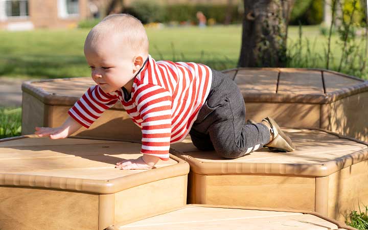 A toddler crawling outside