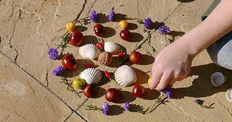 Child creating a nature mandala