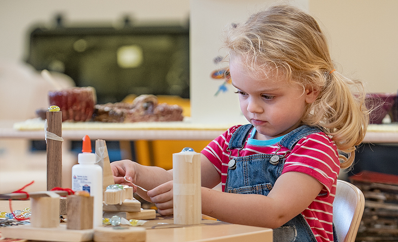 Girls gluing blocks