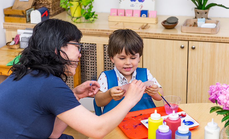 Teacher doing project with child