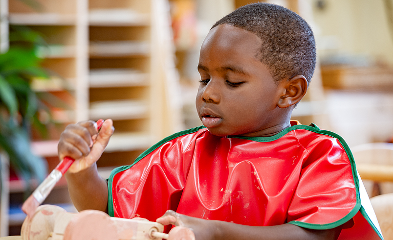 Boy in red apron