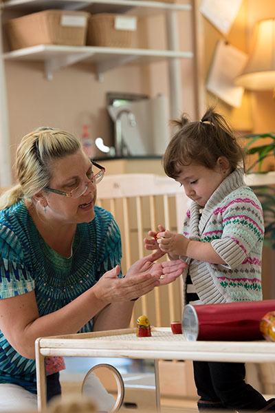 adult and child playing with open ended materials together