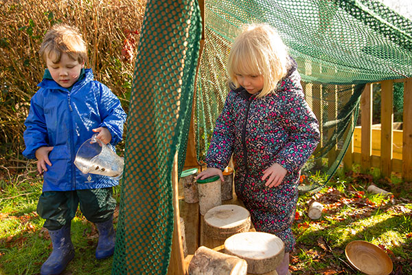 two children playing in an Outlast arbour