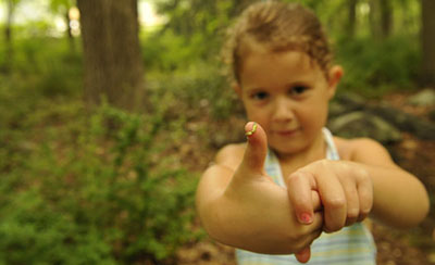 Outdoor exploration child with inchworm