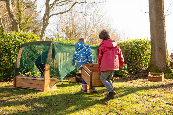 two young boys carrying an Outlast crate