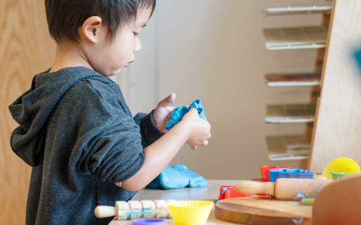 A boy at primary school working with clay.