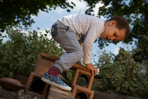 boy climbing on outlast block structure