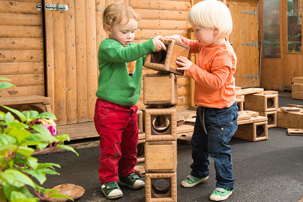 two boys playing with Outlast blocks