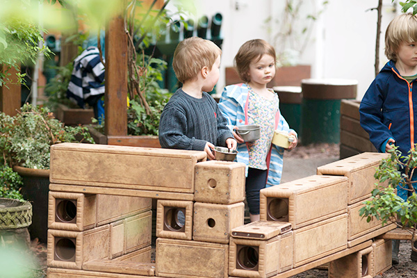 boy and girl playing with Outlast blocks