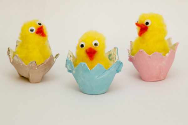 three pompom chicks in egg-crate nests