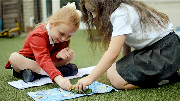 a child and teacher doing an activity together