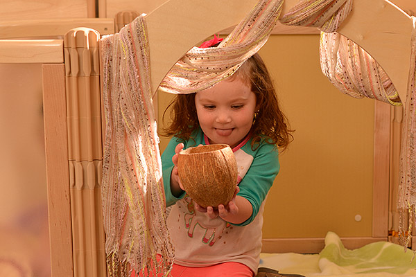 Child playing in an enclosed den area