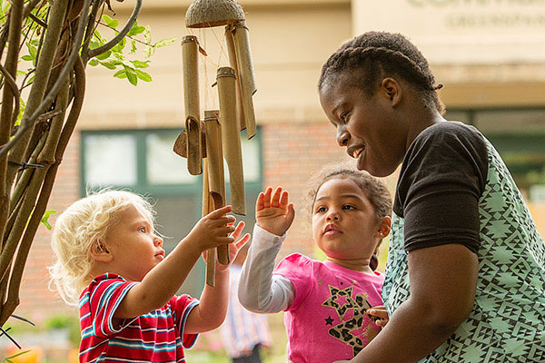 Children and teacher enjoying windchimes