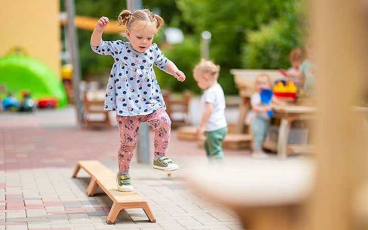 Girl on outlast balancing beam