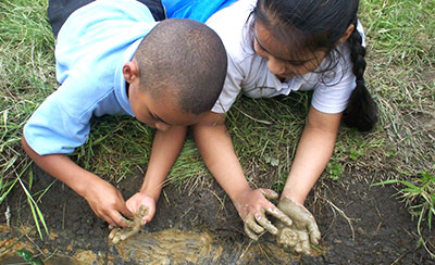 children playing in the mud
