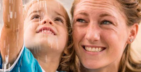 Girl and teacher smiling at the rain