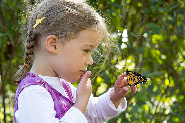 Girl with butterfly on finger