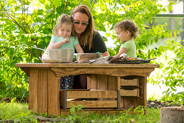 teacher with children at the outlast mud kitchen