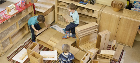 Children playing with hollow blocks in a construction area