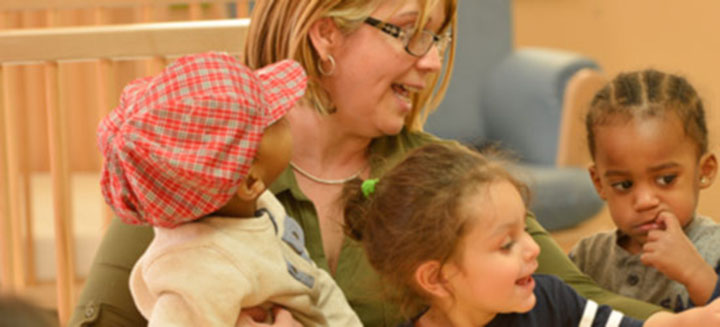 nursery teacher and children singing