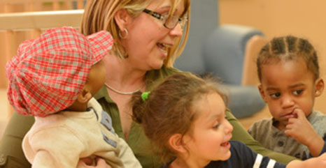 nursery children singing with teacher