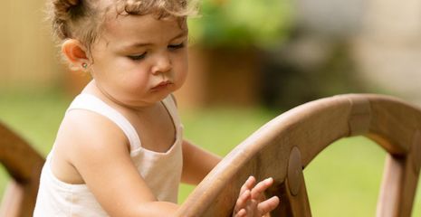 Girl on Outlast bridge looking at hand