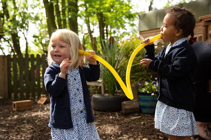 2 kids with plastic tube