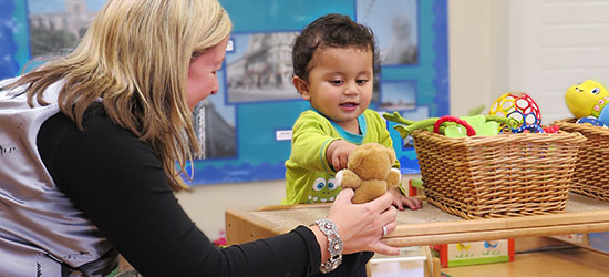 toddler and teacher playing together