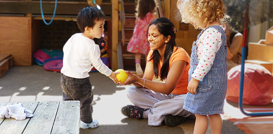 teacher and child playing ball together