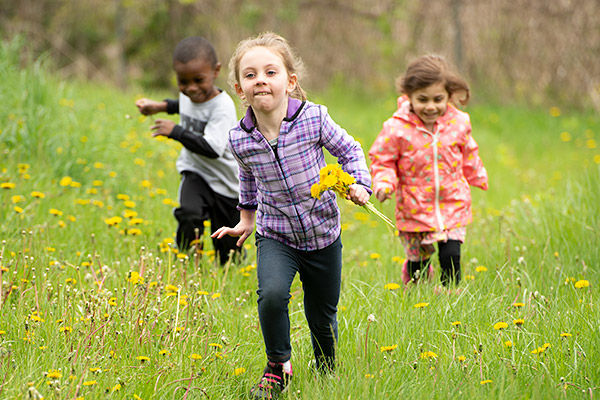 3 children running in field