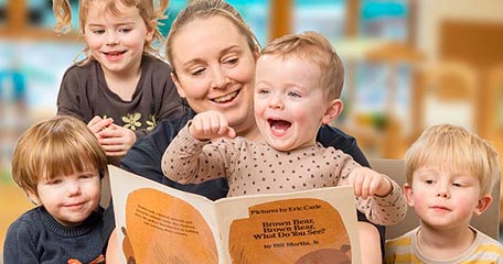 Teacher reading to a group of children