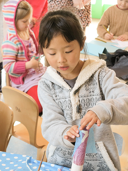 A girl is working on a crafts project