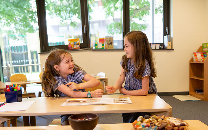 2 primary school girls laughing