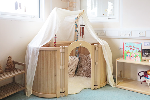 cosy space roomscapes corner with cushions and a baby shelf nearby