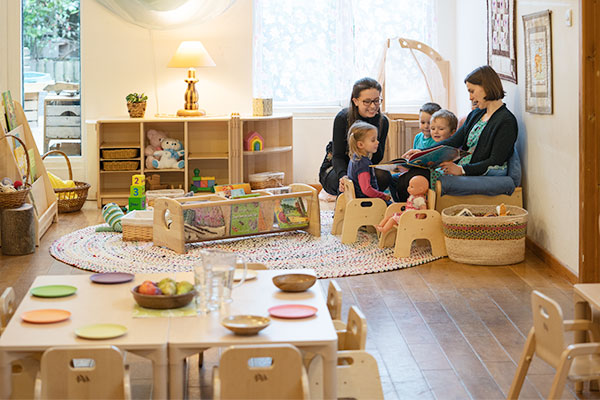 children enjoy story time on a low sofa