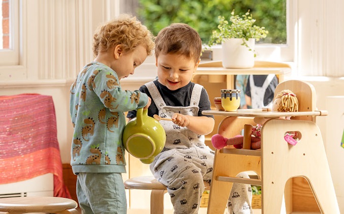 toddlers playing with teapot