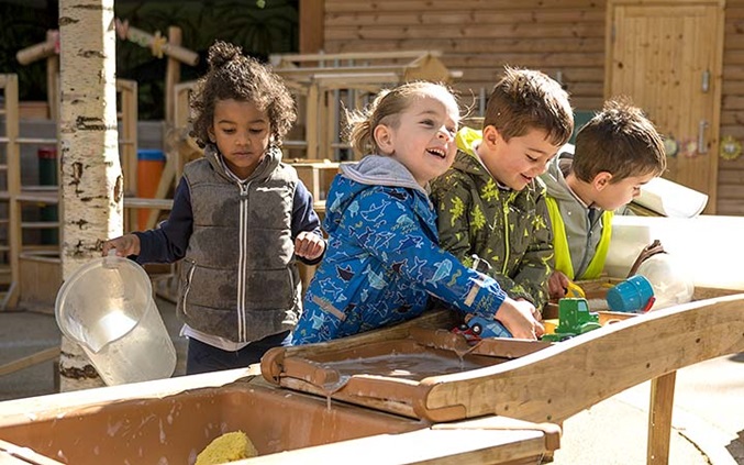Children playing with water and toys at an Outlast Cascade water station.