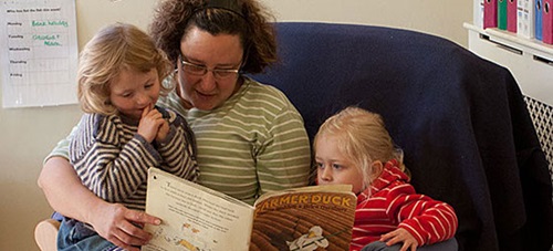 A teacher is reading to children