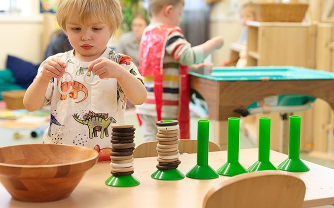Child counting loose parts