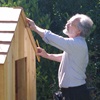 Dr. Francis Wardle measuring the roof of a play house