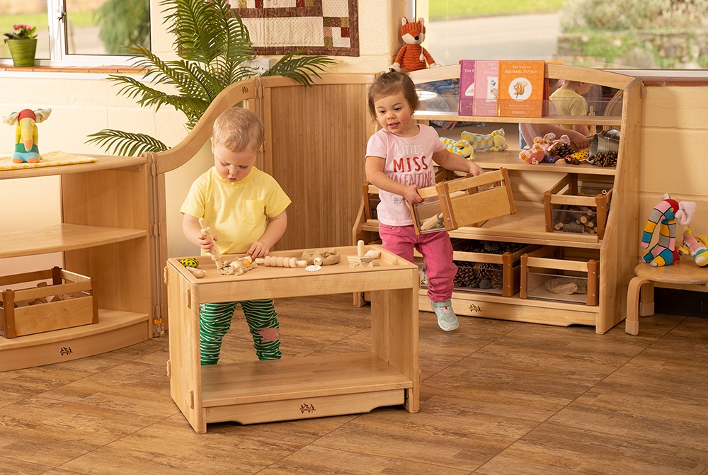 Toddlers playing with display furniture