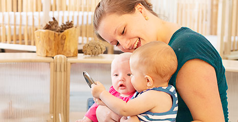 A practitioner holding two babies