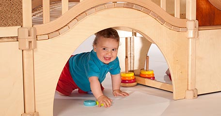 A child playing in the nursery gym