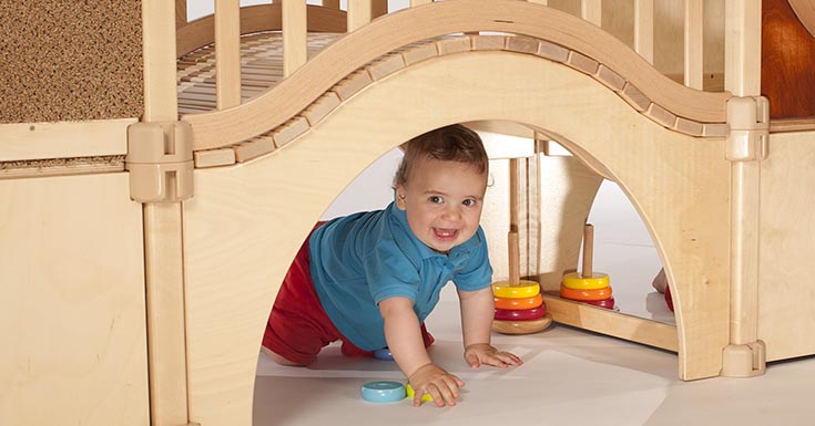 A child playing in the nursery gym