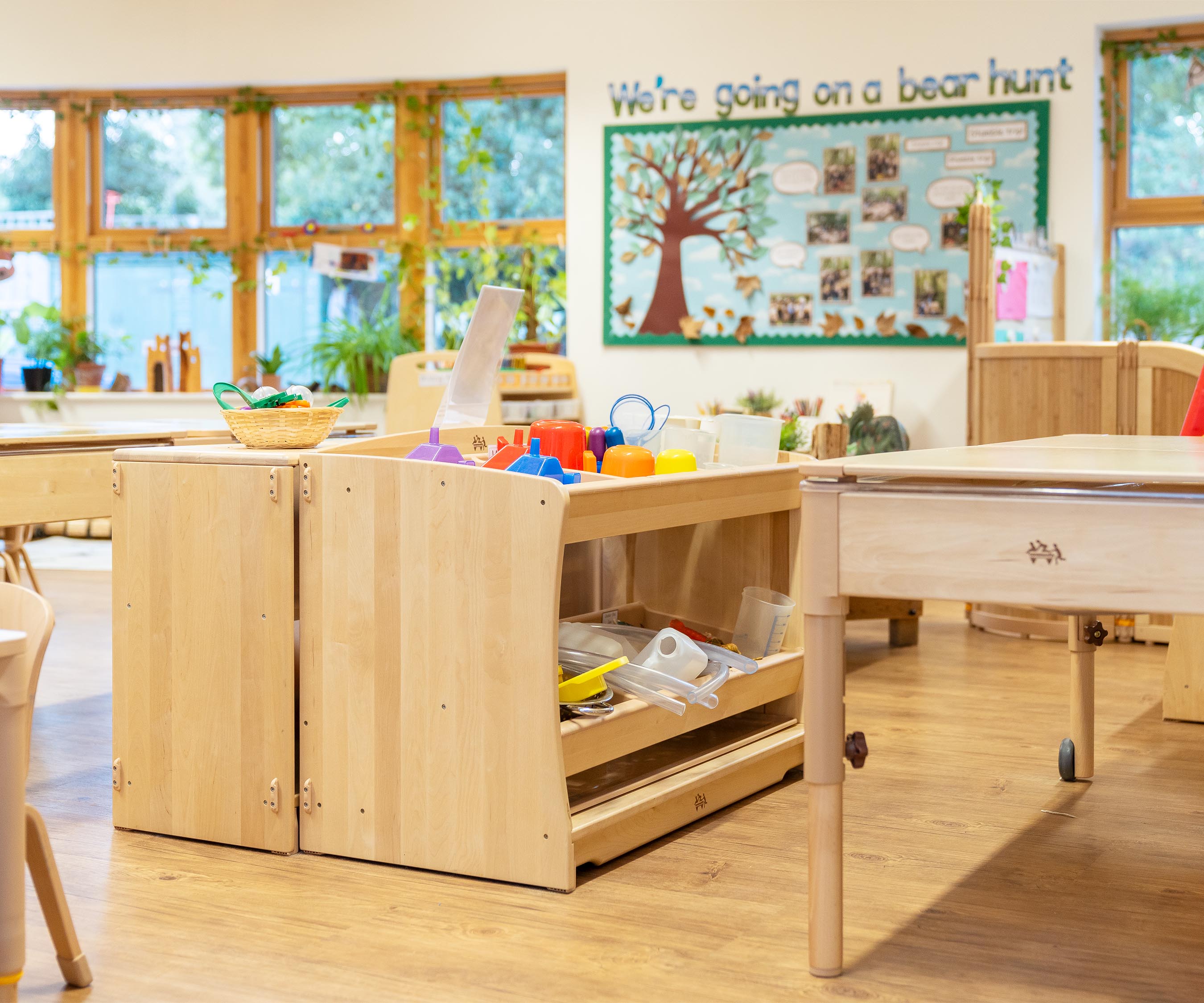 Sand and water storage shelf holding sensory play resources