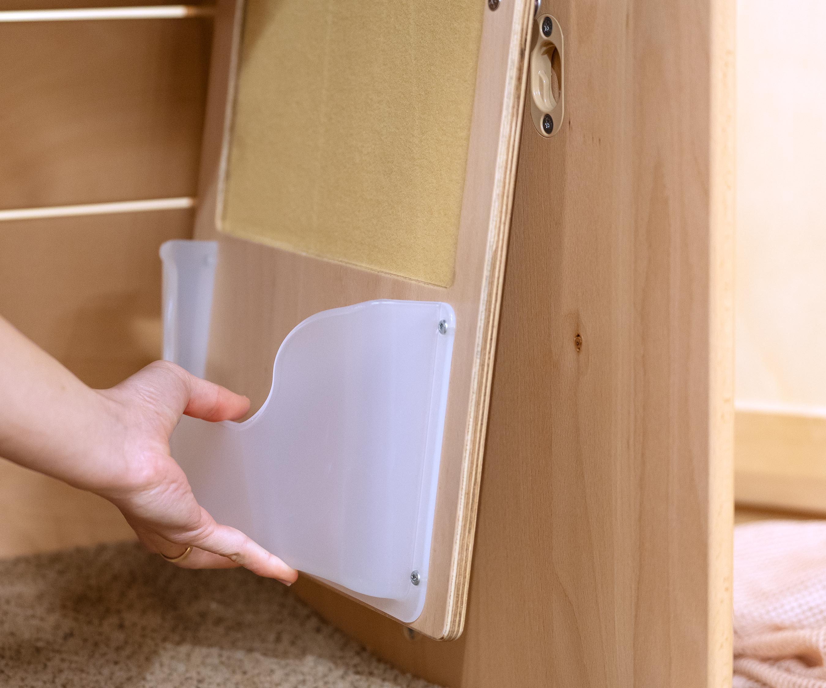 A teacher placing a Felt Board with Pocket into a Nest Nook.