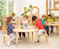 Children in a nursery sitting on stacking stools
