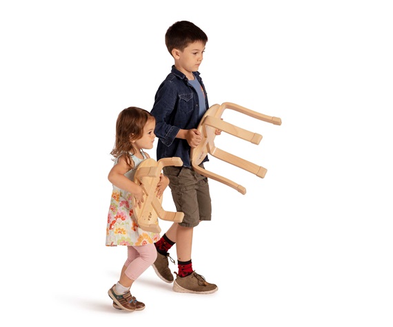 Two children carrying different sizes of stacking stools
